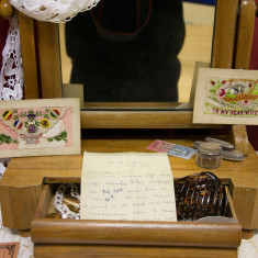 A wife's dressing table with original, silk, handmade postcards and a letter bearing bad news | Alan McDermott